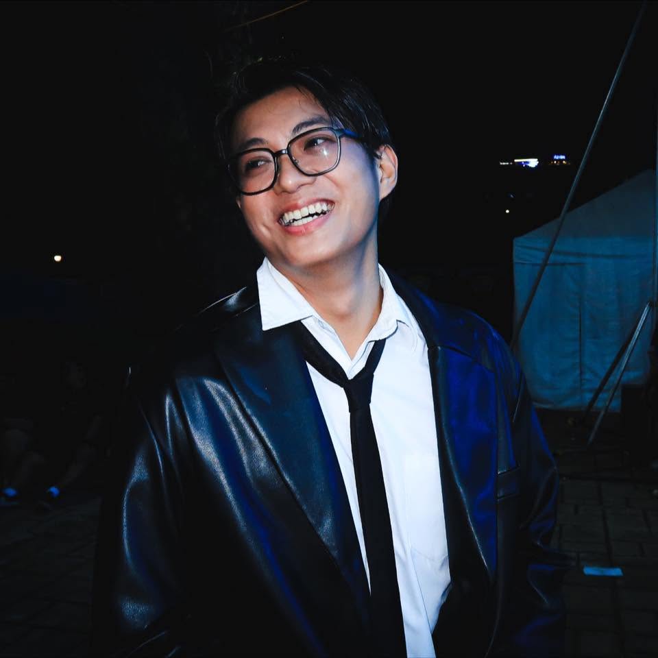 Clod Peña smiling in glasses and a black suit